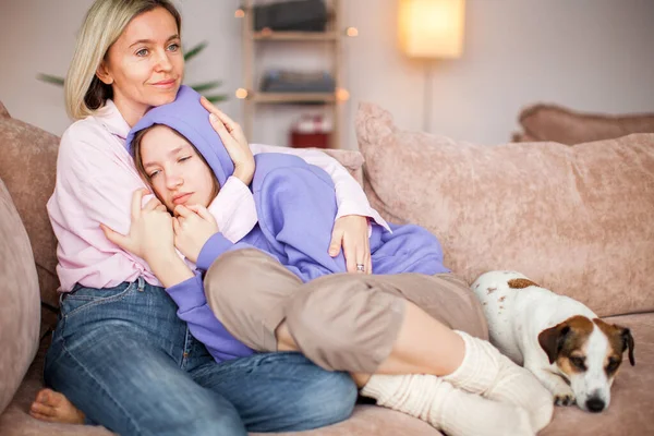 Caring Caucasian mother talk support unhappy upset teen daughter suffering from school bullying or discrimination problems. Loving mom comfort cheer sad teenage girl child, make peace after fight. Woman with child at home