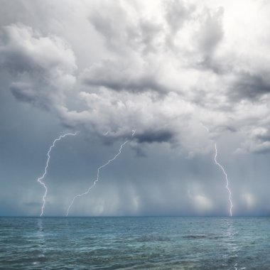 Lightning and thunderstorm above sea clipart
