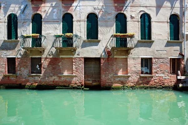 Fassade de velha casa veneziana em pé na água — Fotografia de Stock