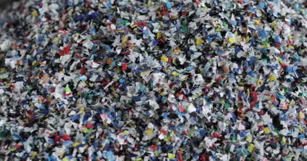 Shredded multi-colored plastic. Close-up. Waste recycling stage. — Vídeo de Stock