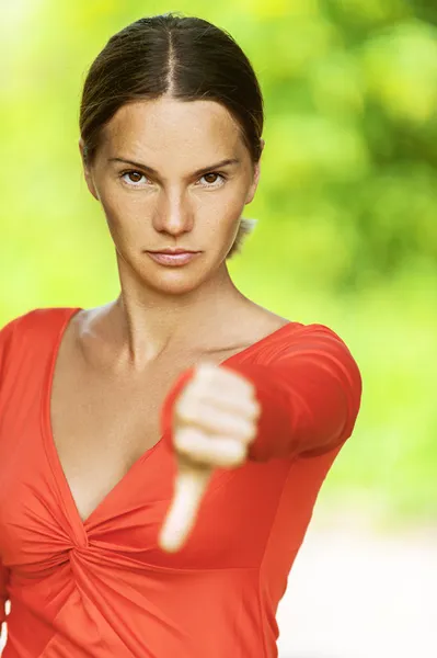 Young woman dangles thumb — Stock Photo, Image