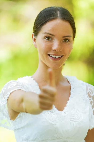 Young woman lifts thumb upwards — Stock Photo, Image