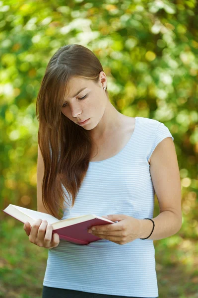 Νεαρή γυναίκα διαβάζει το βιβλίο — Φωτογραφία Αρχείου