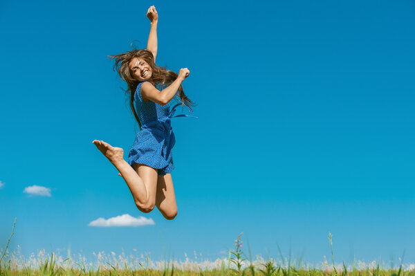 happy young woman jumping high in air