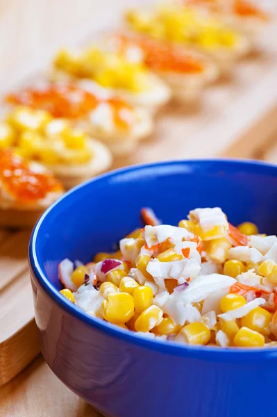 Salad with corn in blue plate — Stock Photo, Image