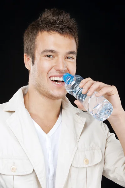 Handsome man drinks water from bottle Royalty Free Stock Images