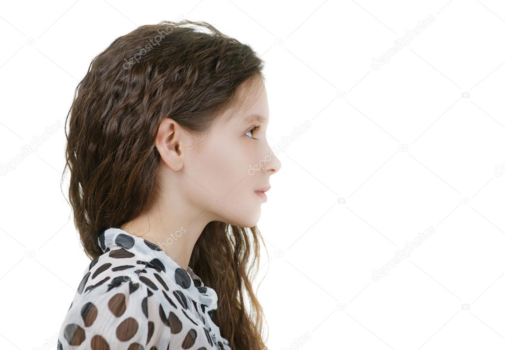 smiling schoolgirl with dark curly hair in profile