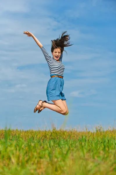 Beautiful woman jumping high Stock Picture