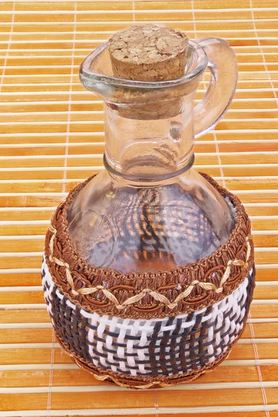 Glass jar with wicker elements — Stock Photo, Image
