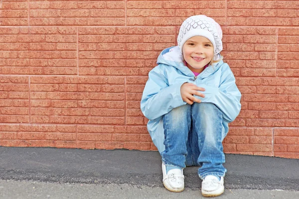 Beautiful little girl sitting — Stock Photo, Image