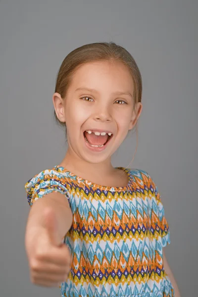 Cheerful girl lifts thumb upwards — Stock Photo, Image