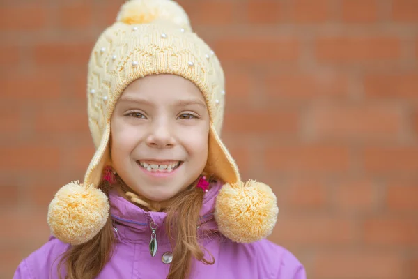 Little girl in yellow hat and pink jacket — Stock Photo, Image