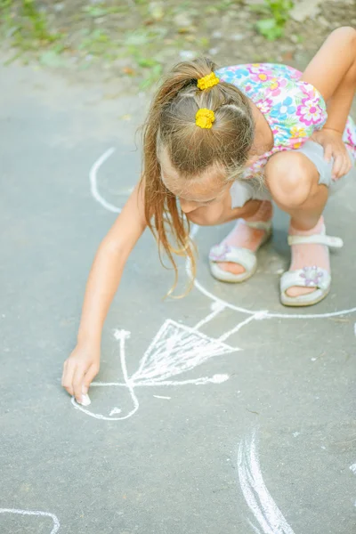 Little girl draws with chalk Stock Photo