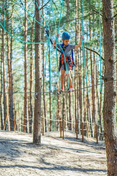 Little girl climbs on rope harness — Stock Photo, Image