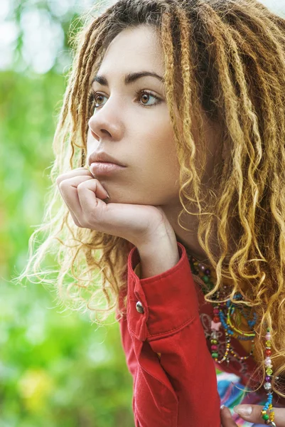 Pensive woman with dreadlocks closeup — Stock Photo, Image