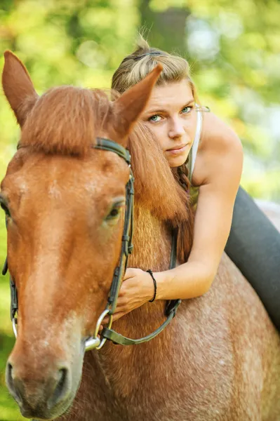 Beautiful young woman on horseback Stock Image