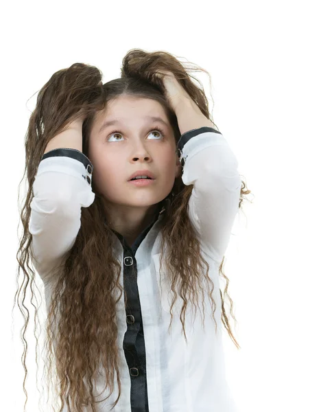 Překvapený školačka s tmavými kudrnatými vlasy — Stock fotografie