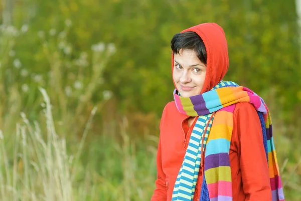 Girl in hood with multi-colored scarfs — Stock Photo, Image