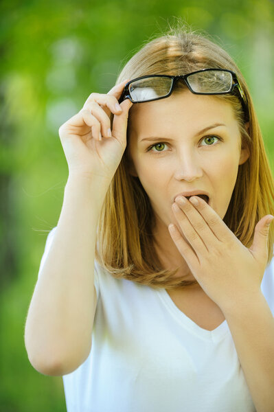 Surprised woman covers with palm of mouth