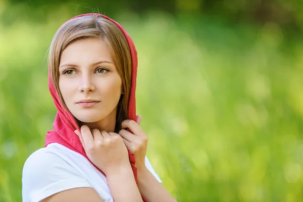 Portrait of young smiling woman wearing kerchief — Stock Photo, Image