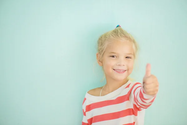 Cheerful girl lifts thumb upwards — Stock Photo, Image