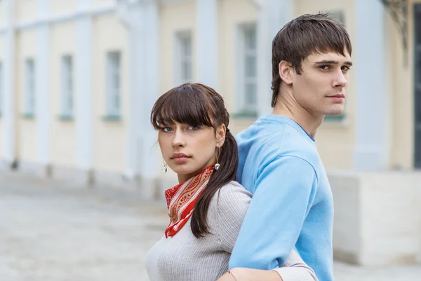 Pretty couple standing back to back — Stock Photo, Image