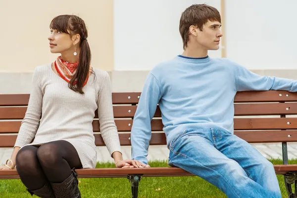 Hombre y mujer sentados en el banco — Foto de Stock