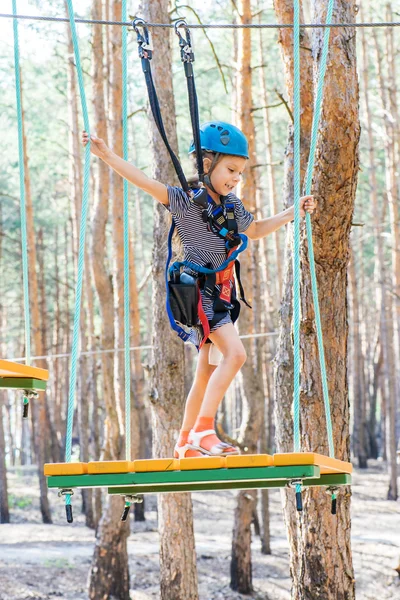 Little girl climbs on rope harness — Stock Photo, Image