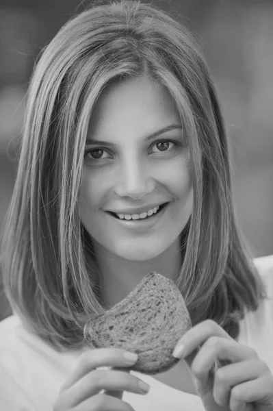 Portrait of woman eating bread — Stock Photo, Image