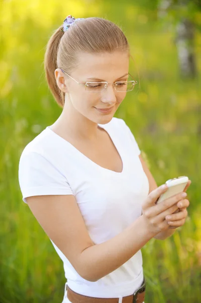 Fair-haired woman looking at phone — Stock Photo, Image