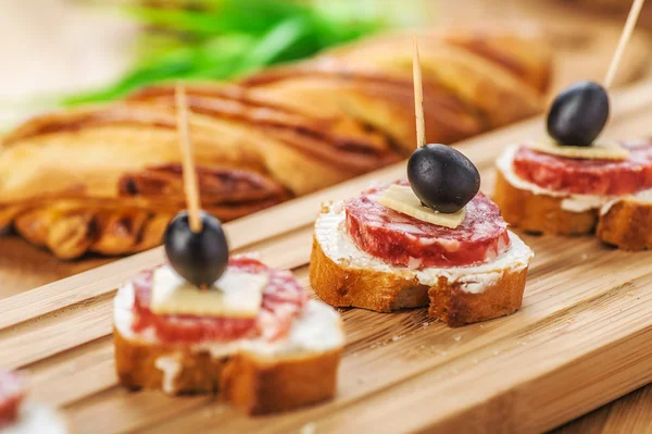 Sausage sandwiches, cheese and olives Stock Photo