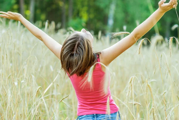 Young female stands in crop field — Stock Photo, Image