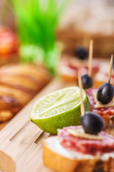 Sausage sandwiches, cheese and olives — Stock Photo, Image