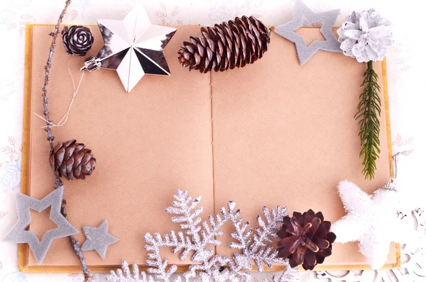 Open old book with brown paper, cones and felt stars — Stock Photo, Image