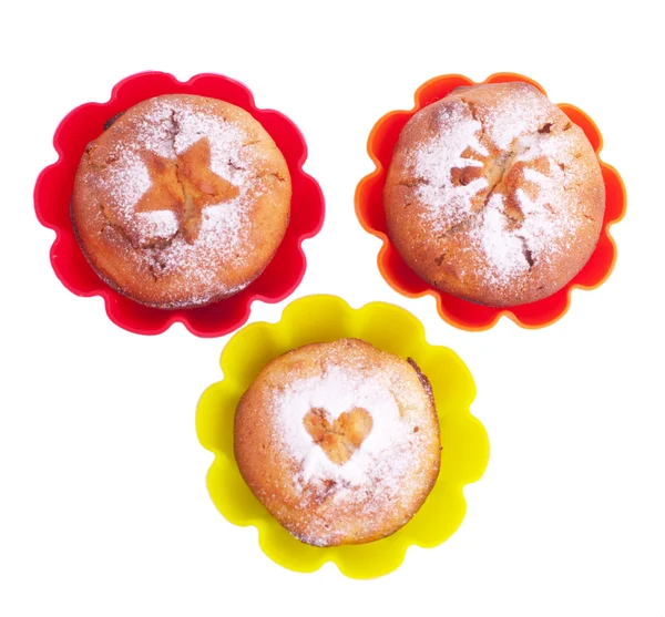 Muffin with icing sugar star, heart and sun in color forms — Stock Photo, Image