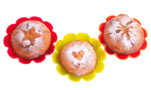 Muffin with icing sugar star, heart and sun in color forms — Stock Photo, Image