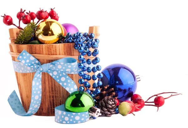 Christmas background with wood bucket, cones, color balls and be — Stock Photo, Image