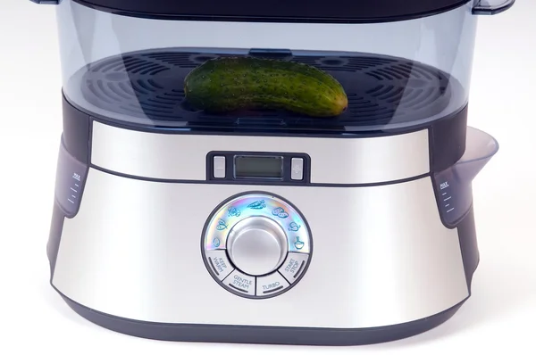 Modern electric steamer with fresh cucumber on a white background — Stock Photo, Image