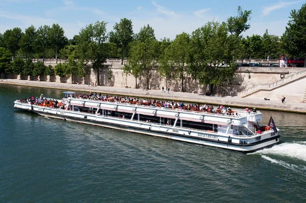 Río Sena con barco de turistas en París, Francia. Cada día miles de turistas utilizan estos barcos para observar el París —  Fotos de Stock