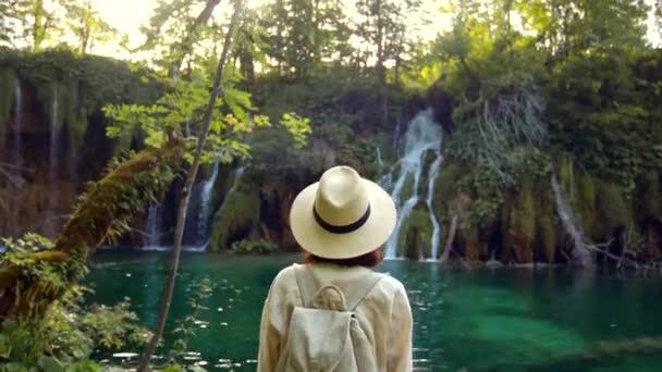 Молода жінка дивиться на водоспади — стокове відео