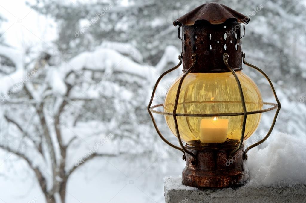vintage lantern against the winter garden