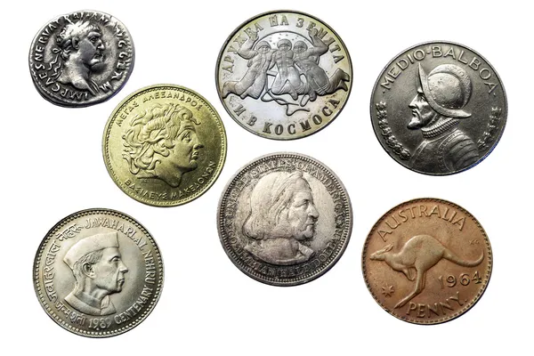 Different old collector's coins with a magnifying glass, blurred