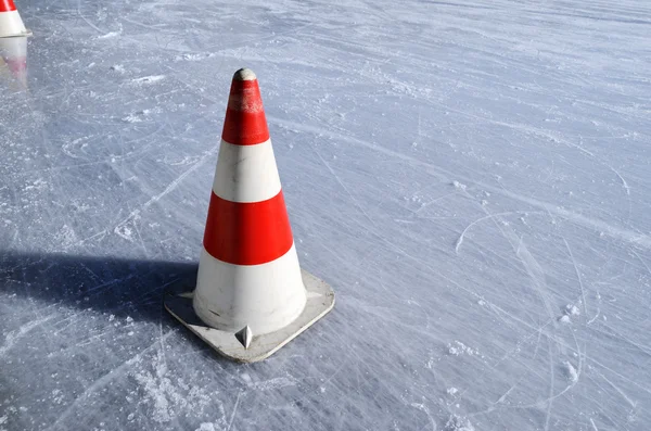 Red white striped cones on the rink — Stock Photo, Image