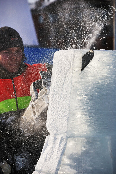 PETROZAVODSK, RUSSIA, FEBRUARY 15: artist is cutting iceblock w
