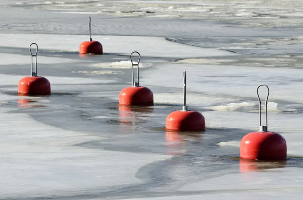 Red buoys in the frozen water — Stock Photo, Image