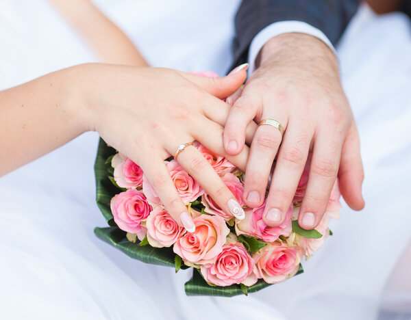 Hands and rings it is wedding bouquet