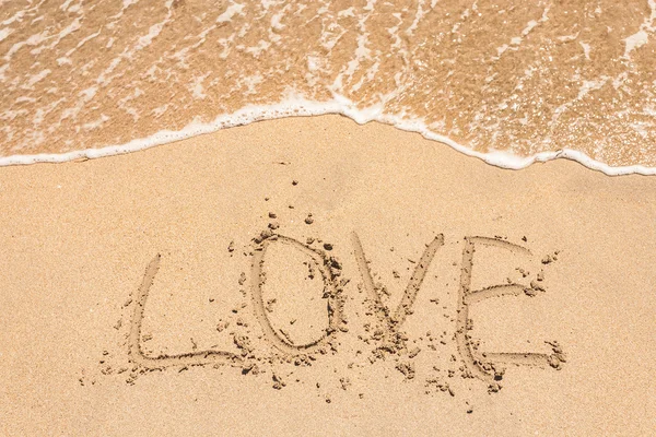 Love handwritten in sand for natural Royalty Free Stock Photos