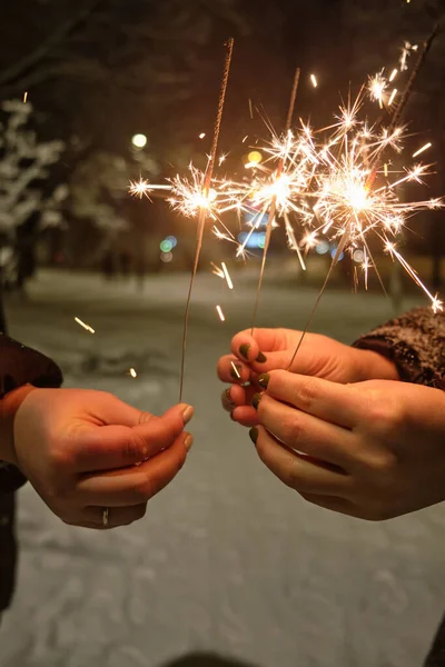 Cheerful Young Female Friends Holding Sparklers Having Fun Holiday Winter — Stock Photo, Image