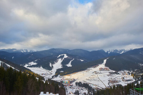 Beautiful view of Carpathian mountain ski resort, winter snowy landscape                               