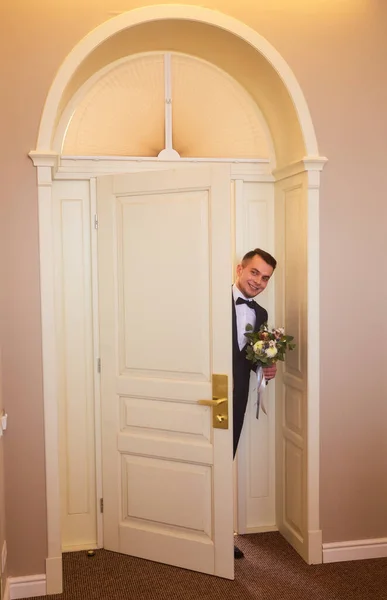 Happy Handsome Groom Bouquet Entering Room — Stock Photo, Image